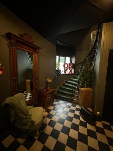 a living room with a checkered floor and stairs at Hotell Onyxen in Gothenburg