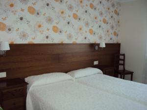 Łóżko lub łóżka w pokoju w obiekcie Casa Fuentes