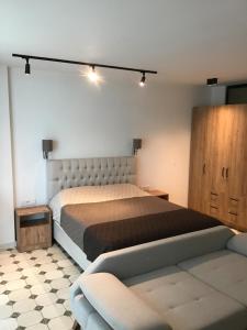 a bedroom with a large bed and a couch at Batumi Sea View in Batumi