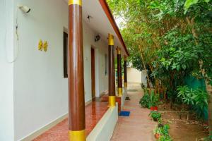 a corridor of a house with bamboo poles at Mahabs homestay Villa in Mahabalipuram