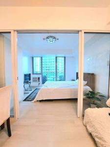 a large bedroom with a bed and a large window at Velvet Waves in Manila