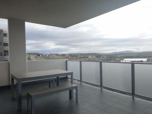 a balcony with two benches on top of a building at Modern & Relaxed Apartment, Great Views @Wright in Weston Creek