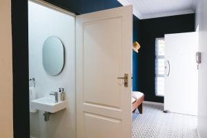a bathroom with a white door and a sink at Cherry Blossom - Backup Power Inverter in Ceres