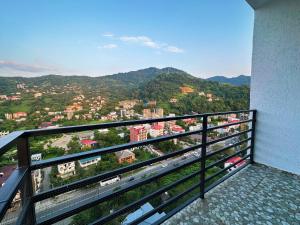 a balcony with a view of a city at Blue Apartment in Gonio
