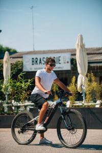 a man riding a bike down a street at Locanda del Musso con Ristorante in Adria