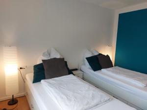 En eller flere senge i et værelse på Rooftop Apartments - Doppelzimmer in Gemeinschaftsunterkunft (Weinberg R2)