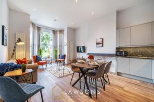 a kitchen and living room with a table and chairs at Executive Living by Lawsons 3 Bed, 3 Bath Apartment in Portsmouth