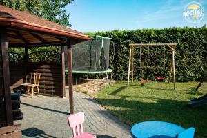 a backyard with a playground and a swing at Azyl in Dębki
