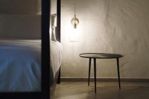 a room with a bed and a table and a lamp at Casa Marinari in Scalea