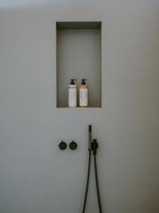 a bathroom with a mirror and two bottles of soap at 1280 Krone in Geisingen