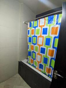 a shower with a colorful shower curtain in a bathroom at Jannat azaytoun in Marrakesh