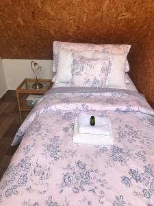 a bed with a towel with a candle on it at Apartmán Pod Věží in Telč