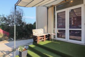 a patio with a chair and an umbrella at Студио Ариел in Varna City