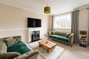 a living room with two couches and a tv at Tranquil 3BD Haven by the Sea in Littlehampton in Littlehampton
