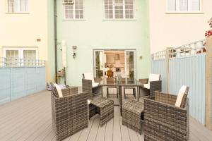 a patio with a table and chairs on a deck at Tranquil 3BD Haven by the Sea in Littlehampton in Littlehampton