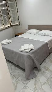 a large bed with two white towels on it at B&b PAESTUM ROOM in Paestum