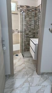 a bathroom with a shower and a sink at B&b PAESTUM ROOM in Paestum +10 photos