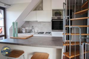 a kitchen with white cabinets and a stove top oven at Azyl in Dębki