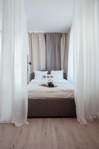 a bedroom with a bed with white drapes at Homewell Apartments Game and Movie in Poznań