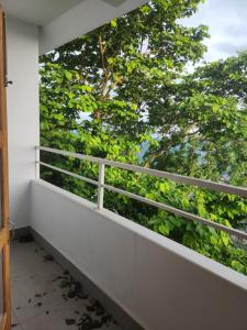 a balcony with a view of a tree at Unit 5 in Āīzawl