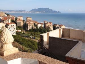 a view of a city and the ocean from a building at BOUS Appartement Tichy 2 in Tichi