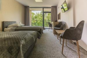 a hotel room with two beds and a window at Centralny Ośrodek Sportu - Giżycko in Giżycko