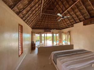 a bedroom with a bed and a ceiling fan at Xixim Mundo Imperial Wellness All Inclusive in Celestún