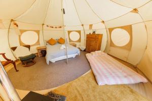 a bedroom with a bed in a tent at South Devon Luna Bell Tent in Newton Abbot
