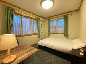 - une chambre avec un lit, une table et des fenêtres dans l'établissement Five room 120 #SKY TREE #SENSOJI #FreeParking 1292sqft, à Tokyo
