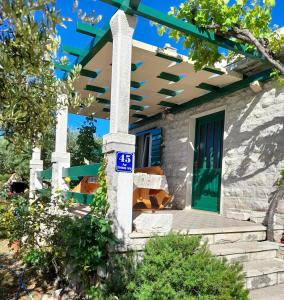 a house with a blue sign on the front porch at Holiday home Ivan Bol in Bol