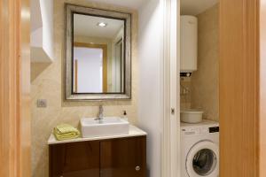 a bathroom with a sink and a washing machine at Atico Asante in Arrecife +12 photos