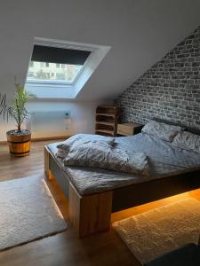 a bedroom with a bed and a brick wall at FeWo Skywalk Willingen in Stryck
