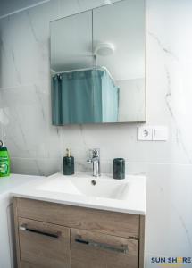 a bathroom with a sink and a mirror at Explore Greece from City Centre Apartment in Chalkida