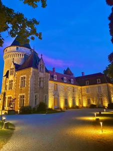 a large castle at night with its lights on at Château de Bouesse en Berry in Bouesse