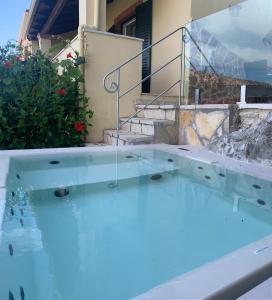 a swimming pool in front of a house at Villa Edem in Kassiopi