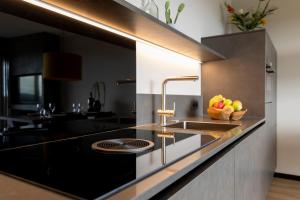 a kitchen with a sink and a bowl of fruit at Weitblick Winterberg in Winterberg