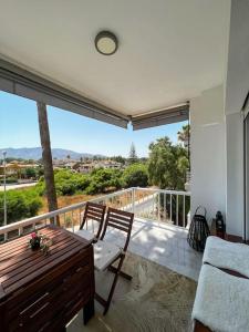a room with a balcony with a table and chairs at NIEUW: Bello Horizonte, house by the sea in Torremolinos