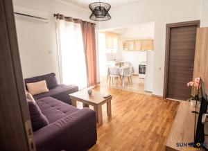 a living room with a couch and a table at Explore Greece from Comfortable City Centre Apartment in Chalkida