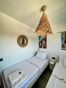 a bedroom with two beds and a mirror on the wall at NIEUW: Bello Horizonte, house by the sea in Torremolinos +25 photos