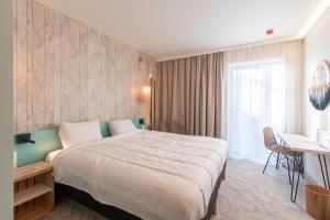 Letto o letti in una camera di ibis Styles Bredene