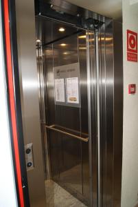 a elevator in a building with a sign on it at Hostal Moreno in Silla