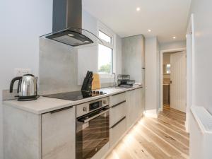 a kitchen with a sink and a stove at Number 9 in Great Yarmouth