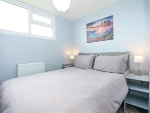 a bedroom with a white bed and a window at Number 9 in Great Yarmouth