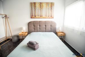 una camera da letto con un grande letto con due comodini di Explore Greece from Apartment with Private Garden a Calcide