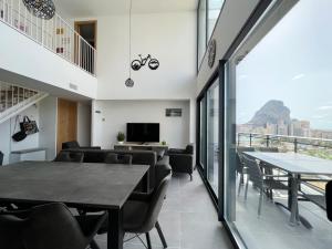 a dining room with a table and chairs at Beautiful duplex modern apartment in Calpe - Inmodream Calpe in Ifach