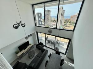 an overhead view of a living room with chairs and a television at Beautiful duplex modern apartment in Calpe - Inmodream Calpe in Ifach