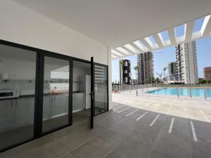 a view of a swimming pool from a house at Beautiful duplex modern apartment in Calpe - Inmodream Calpe in Ifach