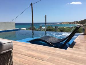 a swing in a pool with the ocean in the background at The Diamond of Kriaritsi "Villas with private pools & hydromassage" in Kriaritsi