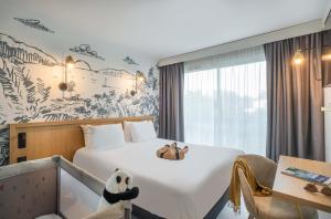 a hotel room with a bed with two teddy bears on it at L'Escale Marine, The Originals Relais in Crozon