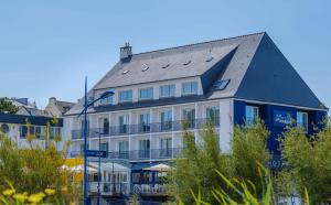 a large white building with a gray roof at L'Escale Marine, The Originals Relais in Crozon